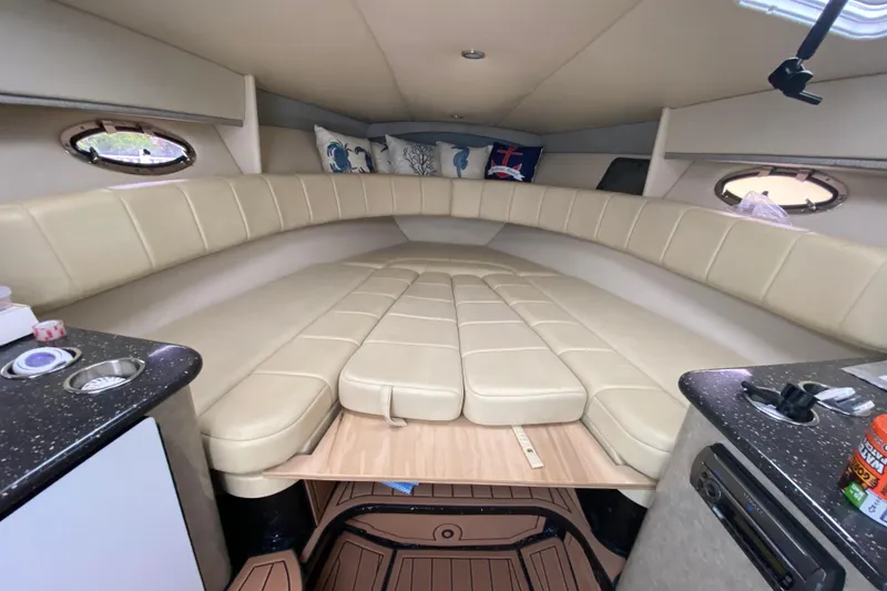 Slide: The Image of Interior of 2009 Formula 330 Sun Sport boat with beige seating and compact amenities. - 21