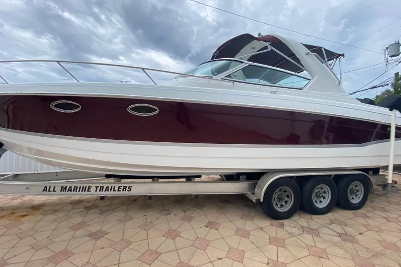 Slide: The Image of 2009 Formula 330 Sun Sport boat on trailer, side view under cloudy sky. - 31