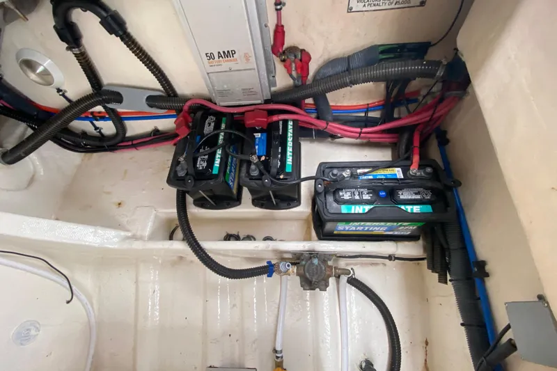 Slide: The Image of 2009 Formula 330 Sun Sport boat battery compartment with wiring and Interstate batteries. - 33