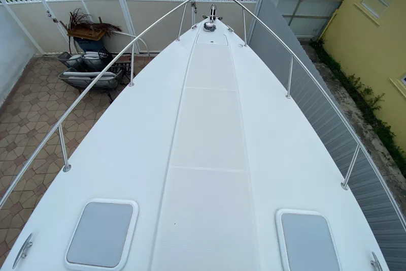 Slide: The Image of 2009 Formula 330 Sun Sport boat deck, featuring sleek design and stainless steel railings. - 6
