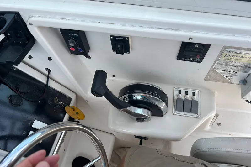 Slide: The Image of 1996 Pro-Line 251 Walkaround boat controls and dashboard with steering wheel and throttle. - 3