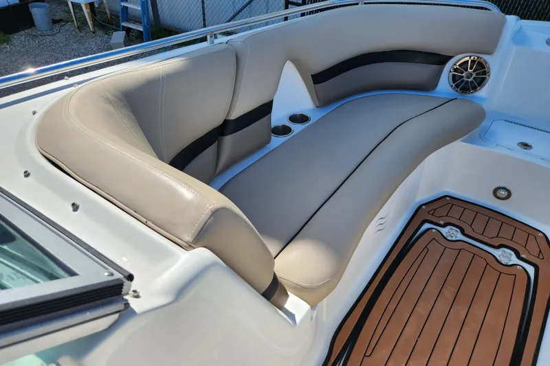Slide: The Image of 2016 Hurricane SunDeck 2400 OB boat interior with beige seating and wood-style flooring. - 14