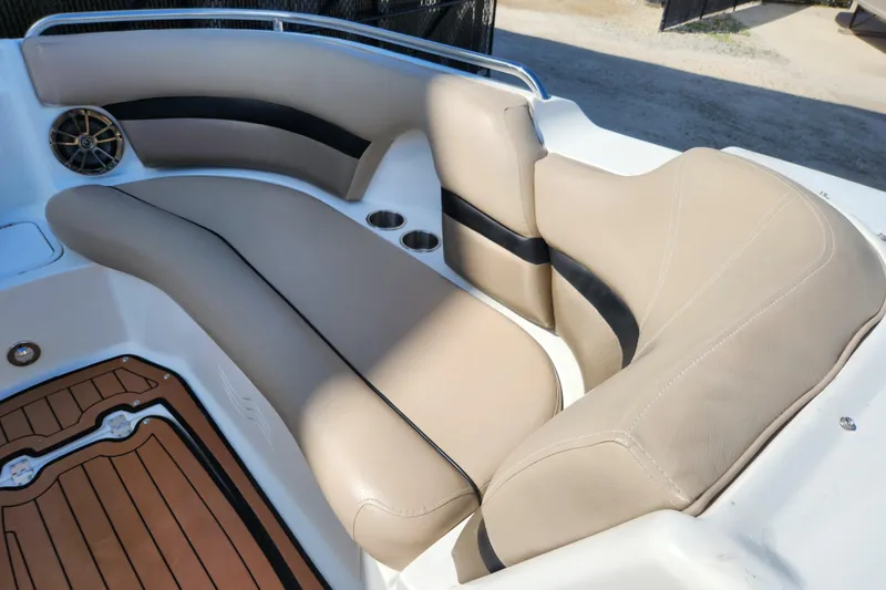 Slide: The Image of 2016 Hurricane SunDeck 2400 OB boat interior with beige seating and wood-style flooring. - 15