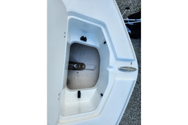 Slide: The Image of 2016 Hurricane SunDeck 2400 OB boat storage compartment with rope inside. - 18