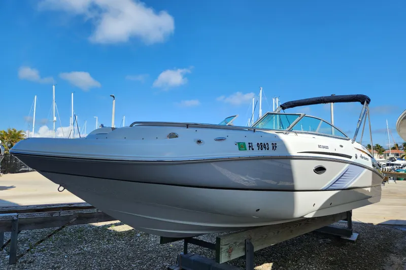 Slide: The Image of 2016 Hurricane SunDeck 2400 OB boat on display under clear blue sky. - 2