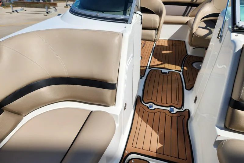 Slide: The Image of 2016 Hurricane SunDeck 2400 OB interior with tan seating and wood-style flooring. - 20