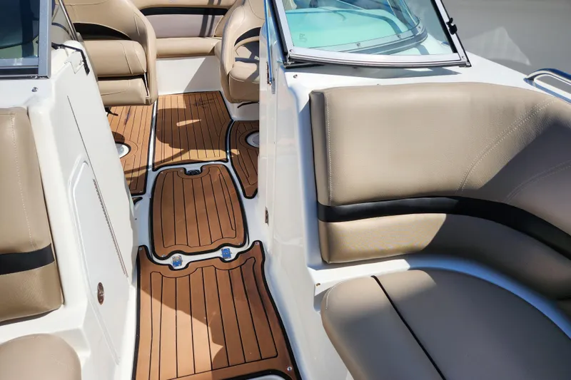 Slide: The Image of 2016 Hurricane SunDeck 2400 OB interior with tan seating and teak-style flooring. - 21