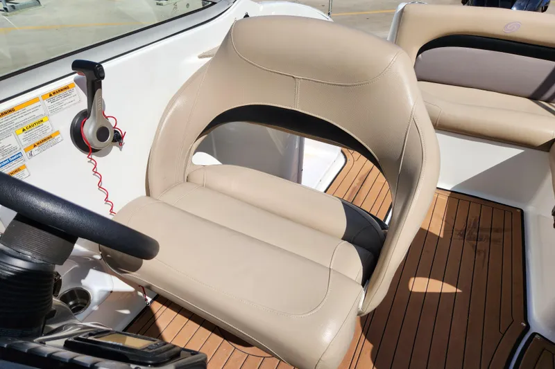 Slide: The Image of Captain's seat on 2016 Hurricane SunDeck 2400 OB boat with steering wheel and control panel. - 25