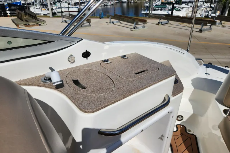 Slide: The Image of 2016 Hurricane SunDeck 2400 OB boat interior with helm and seating area. - 27