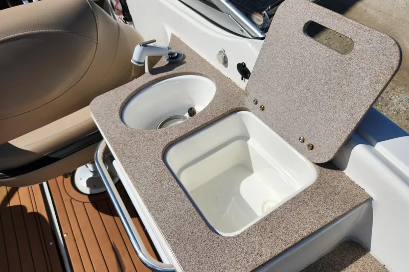 Slide: The Image of 2016 Hurricane SunDeck 2400 OB boat sink and storage compartment. - 28