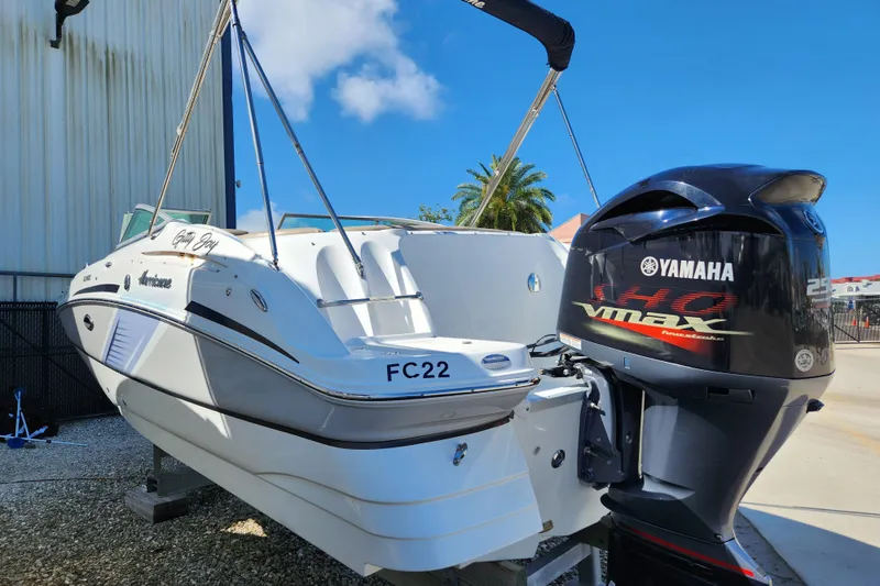 Slide: The Image of 2016 Hurricane SunDeck 2400 OB boat with Yamaha VMAX engine, docked outdoors. - 3