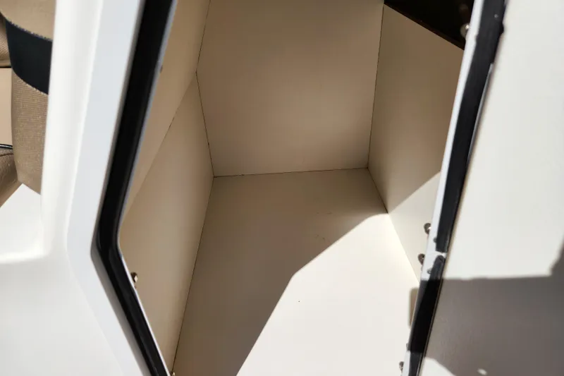 Slide: The Image of Storage compartment inside 2016 Hurricane SunDeck 2400 OB boat, featuring clean, spacious interior. - 31