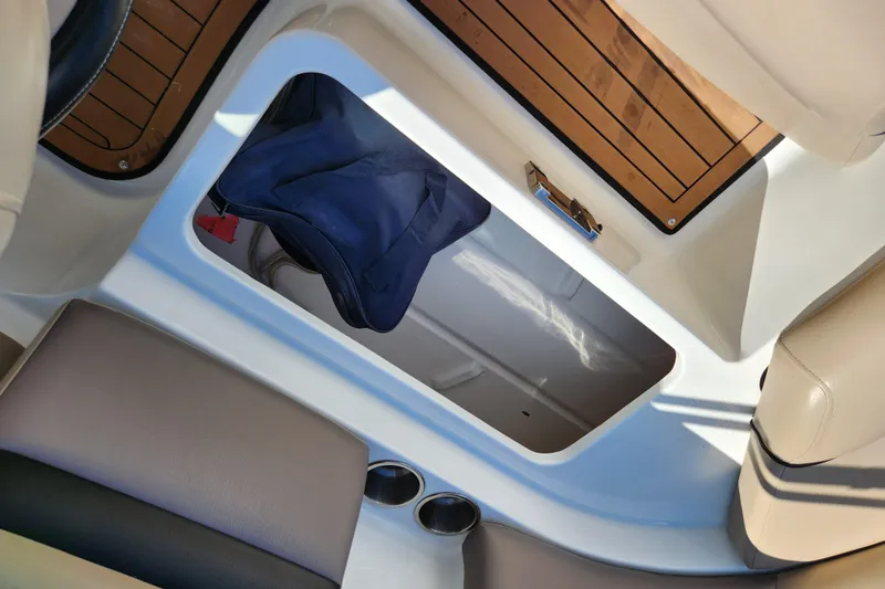 Slide: The Image of Storage compartment on a 2016 Hurricane SunDeck 2400 OB boat with wooden flooring. - 32
