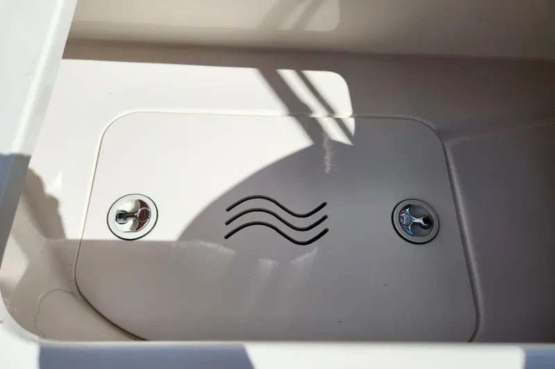 Slide: The Image of 2016 Hurricane SunDeck 2400 OB boat storage compartment with secure locks and wave design. - 35