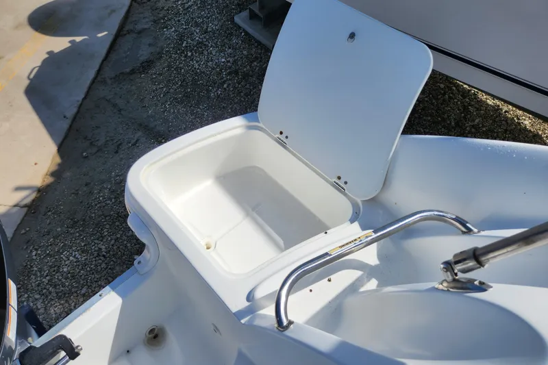 Slide: The Image of Open storage compartment on 2016 Hurricane SunDeck 2400 OB boat. - 38