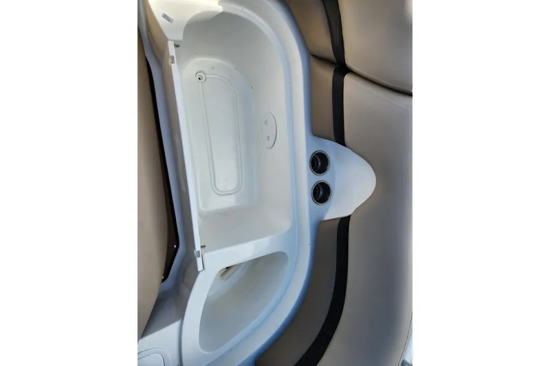 Slide: The Image of 2016 Hurricane SunDeck 2400 OB boat interior storage compartment with cup holders. - 39