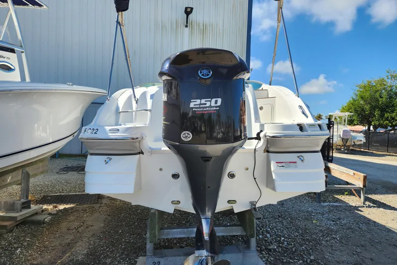 Slide: The Image of 2016 Hurricane SunDeck 2400 OB boat with Yamaha 250 engine, parked outdoors. - 4