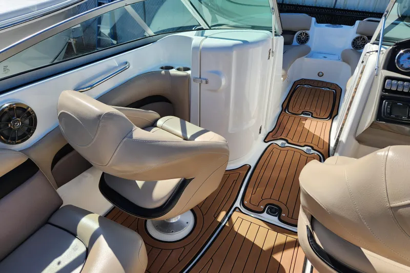 Slide: The Image of 2016 Hurricane SunDeck 2400 OB interior with tan seating and wood-style flooring. - 7