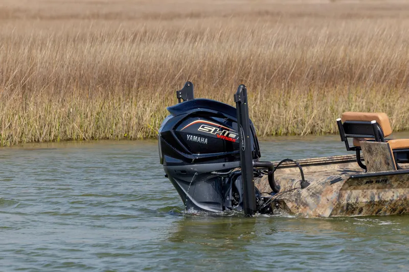 Slide: The Image of 2026 Excel 203 Bay Pro Elite boat with Yamaha motor in shallow water. - 2