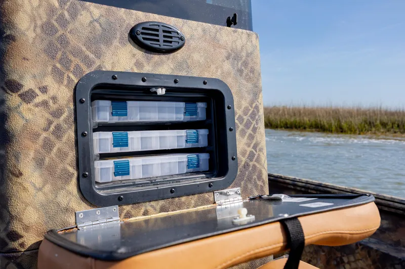 Slide: The Image of Storage compartment on 2026 Excel 203 Bay Pro Elite boat, near water. - 21