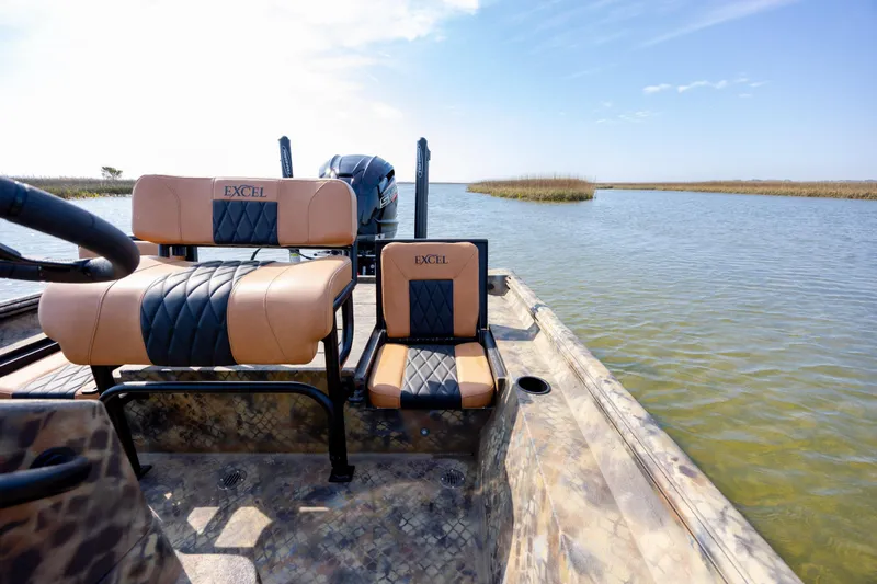 Slide: The Image of 2026 Excel 203 Bay Pro Elite boat on calm water, featuring stylish seating. - 30