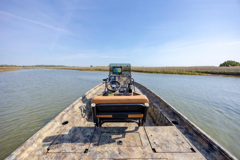 Slide: The Image of 2026 Excel 203 Bay Pro Elite boat navigating calm waters under clear blue sky. - 31