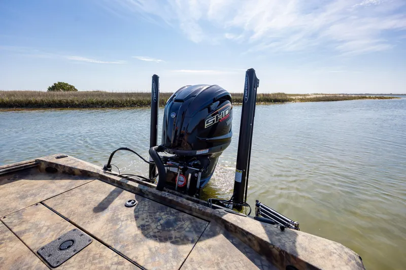 Slide: The Image of 2026 Excel 203 Bay Pro Elite boat with Yamaha motor on calm water. - 33