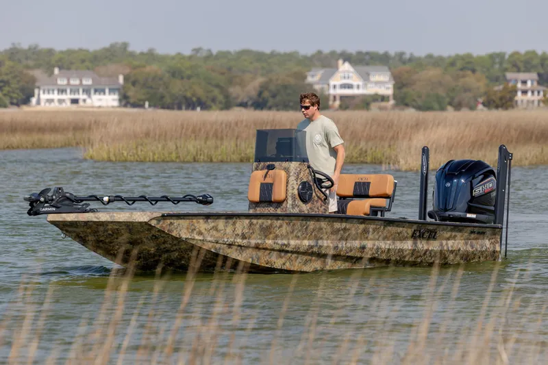 Slide: The Image of 2026 Excel 203 Bay Pro Elite boat navigating through marshland waters. - 6