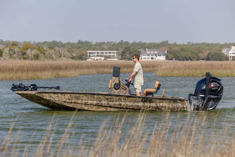 Slide: The Image of 2026 Excel 203 Bay Pro Elite boat navigating through marshland waters. - 7
