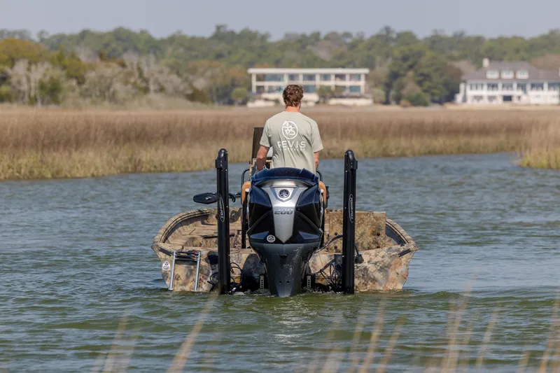 Slide: The Image of 2026 Excel 203 Bay Pro Elite boat navigating a serene waterway. - 9