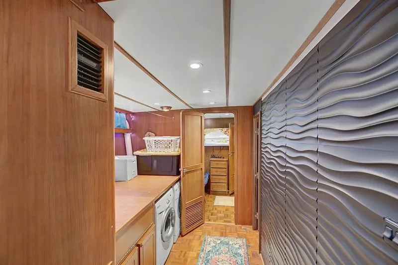 Slide: The Image of Laundry area inside 1989 Jefferson Marquessa 63 yacht with wood paneling and modern design. - 27