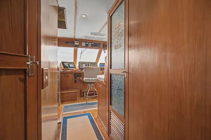 Slide: The Image of Interior view of 1989 Jefferson Marquessa 63 yacht with wooden paneling and navigation equipment. - 6
