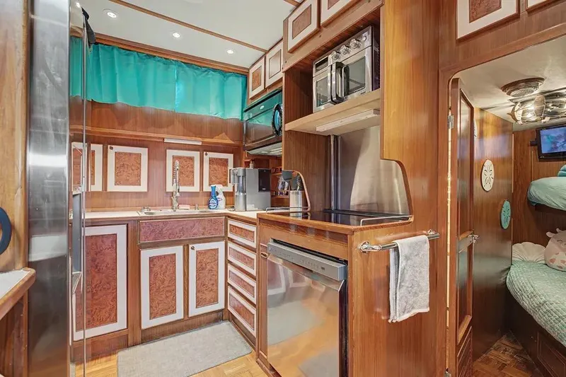 Slide: The Image of Luxurious 1989 Jefferson Marquessa 63 yacht kitchen with wood cabinetry and modern appliances. - 23