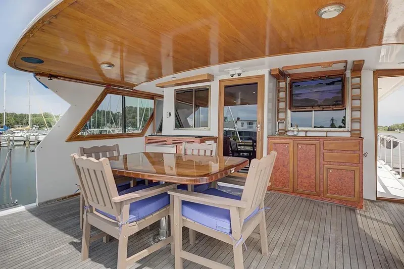 Slide: The Image of Outdoor dining area on 1989 Jefferson Marquessa 63 yacht with wooden table and chairs. - 19