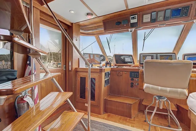 Slide: The Image of Interior of 1989 Jefferson Marquessa 63 yacht with wooden helm and navigation equipment. - 9