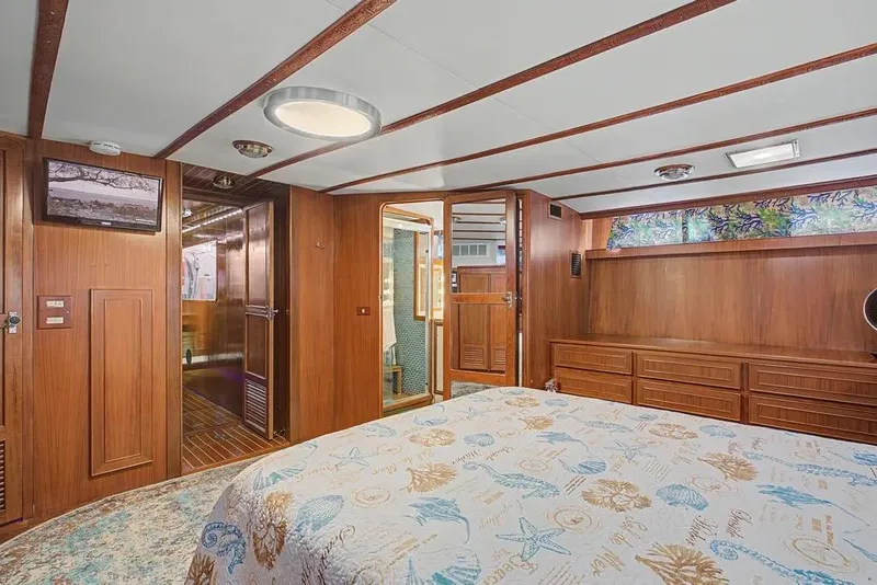 Slide: The Image of Luxurious cabin interior of 1989 Jefferson Marquessa 63 yacht with wood paneling and nautical decor. - 35