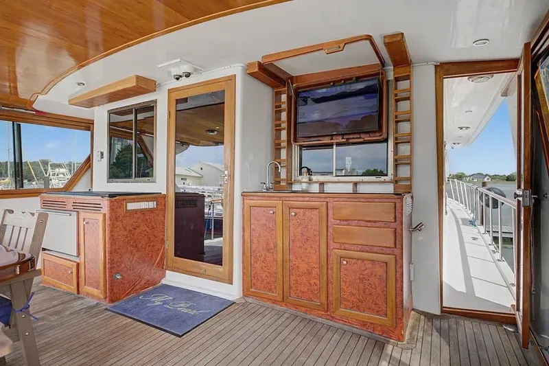 Slide: The Image of Luxurious interior of 1989 Jefferson Marquessa 63 yacht with wood finishes and outdoor view. - 20