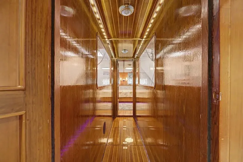 Slide: The Image of Luxurious wooden interior hallway of 1989 Jefferson Marquessa 63 yacht, featuring elegant lighting. - 26