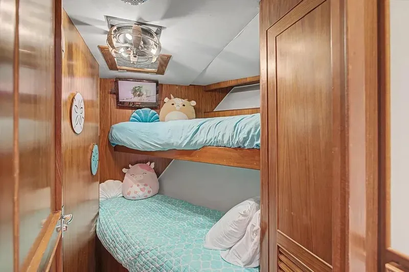 Slide: The Image of Cozy bunk beds with plush toys in a 1989 Jefferson Marquessa 63 yacht cabin. - 25