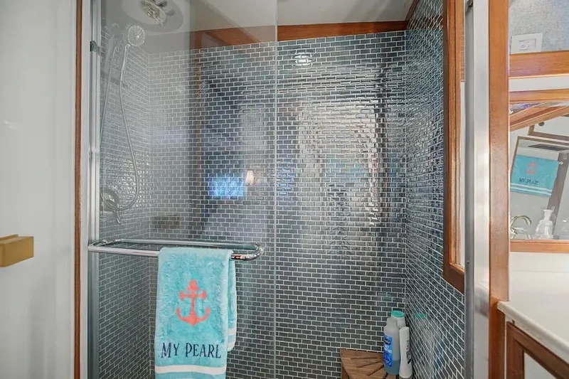 Slide: The Image of Luxurious shower in 1989 Jefferson Marquessa 63 yacht with mosaic tiles and towel rack. - 38
