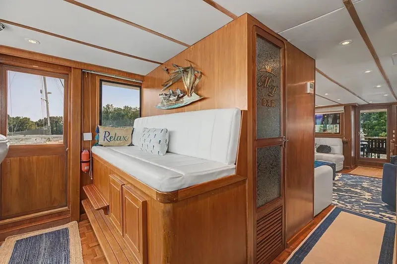 Slide: The Image of Interior of 1989 Jefferson Marquessa 63 yacht with wooden decor and cozy seating area. - 4
