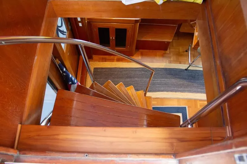 Slide: The Image of Wooden staircase inside 1989 Jefferson Marquessa 63 yacht, featuring polished handrails and elegant interior design. - 43
