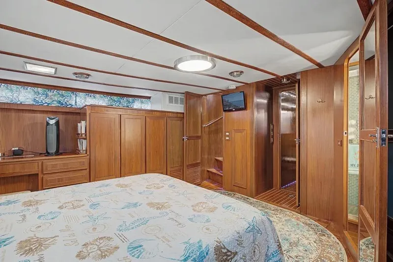 Slide: The Image of Luxurious wood-paneled bedroom interior of 1989 Jefferson Marquessa 63 yacht with nautical decor. - 36