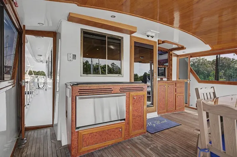 Slide: The Image of Interior of 1989 Jefferson Marquessa 63 yacht with wood accents and outdoor seating area. - 16