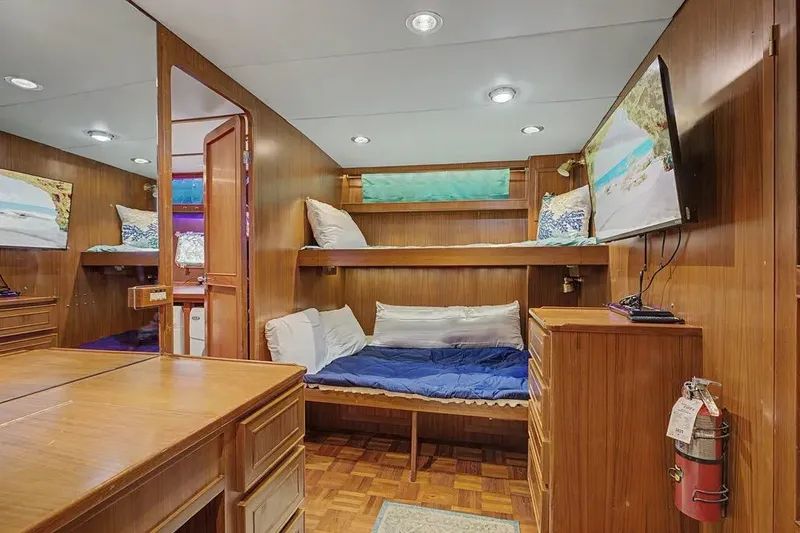 Slide: The Image of Interior of 1989 Jefferson Marquessa 63 yacht with wooden furnishings and cozy bunk beds. - 32