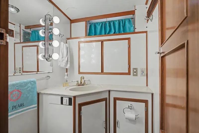 Slide: The Image of Bathroom interior of 1989 Jefferson Marquessa 63 yacht with vanity and mirror lighting. - 31