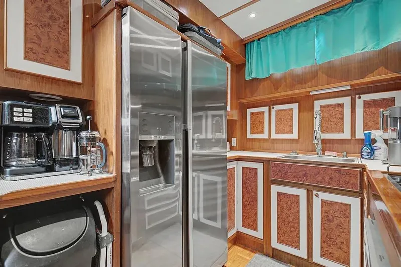 Slide: The Image of 1989 Jefferson Marquessa 63 yacht kitchen with stainless steel appliances and wood cabinetry. - 22