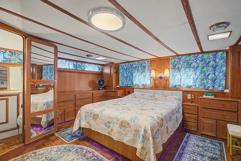 Slide: The Image of Luxurious bedroom interior of 1989 Jefferson Marquessa 63 yacht with wood paneling and nautical decor. - 34