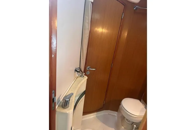 Slide: The Image of Bathroom interior of 2007 Jeanneau Sun Odyssey 42 DS yacht, featuring wooden cabinetry and compact design. - 17