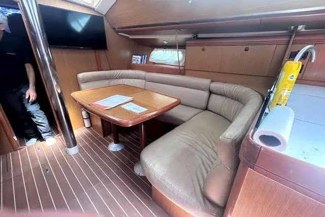 Slide: The Image of Interior of 2007 Jeanneau Sun Odyssey 42 DS yacht with cozy seating and wooden finishes. - 2